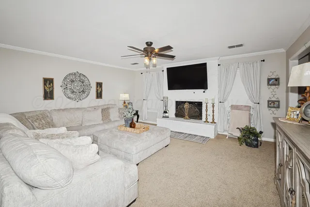 a living room with furniture and a flat screen tv