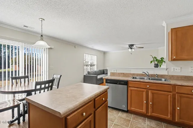 a kitchen with a table chairs and a refrigerator