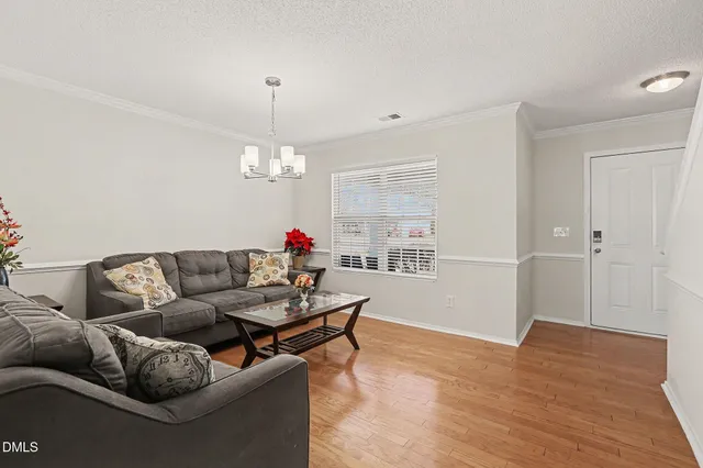 a living room with furniture and a chandelier