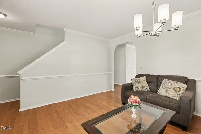a living room with furniture and a chandelier
