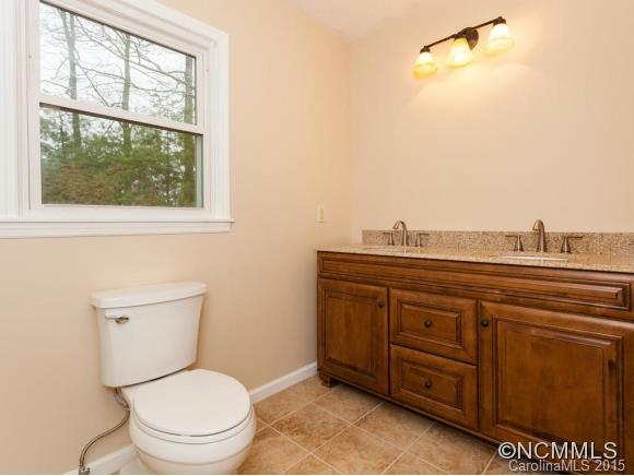 84 Hampton Road Leicester, NC 28748 - Photo 15 of 24 a bathroom with a toilet a sink and a window