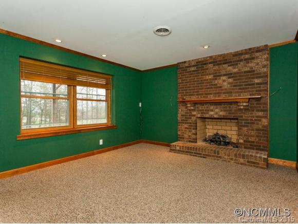 84 Hampton Road Leicester, NC 28748 - Photo 18 of 24 a view of an empty room with a fireplace and a window
