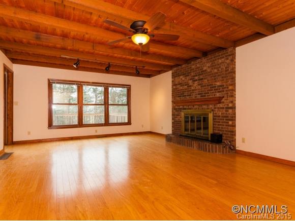 84 Hampton Road Leicester, NC 28748 - Photo 5 of 24 a view of an empty room with a fireplace and a window