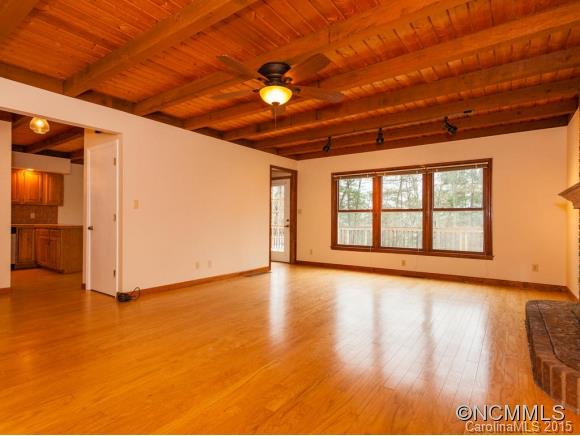 84 Hampton Road Leicester, NC 28748 - Photo 7 of 24 a view of an empty room with wooden floor and a window