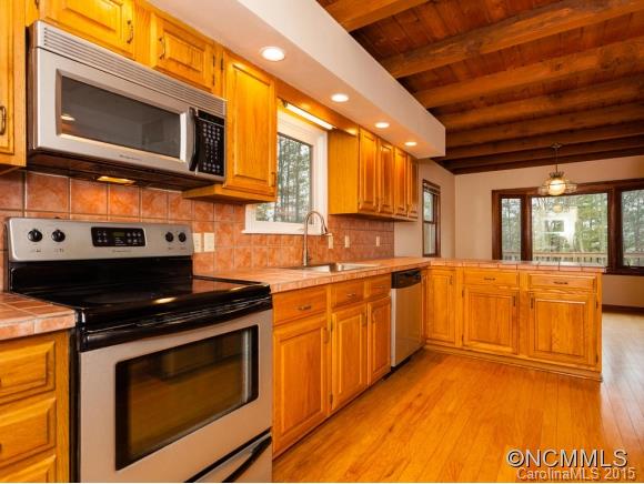 84 Hampton Road Leicester, NC 28748 - Photo 10 of 24 a kitchen with stainless steel appliances granite countertop a stove a microwave and a sink