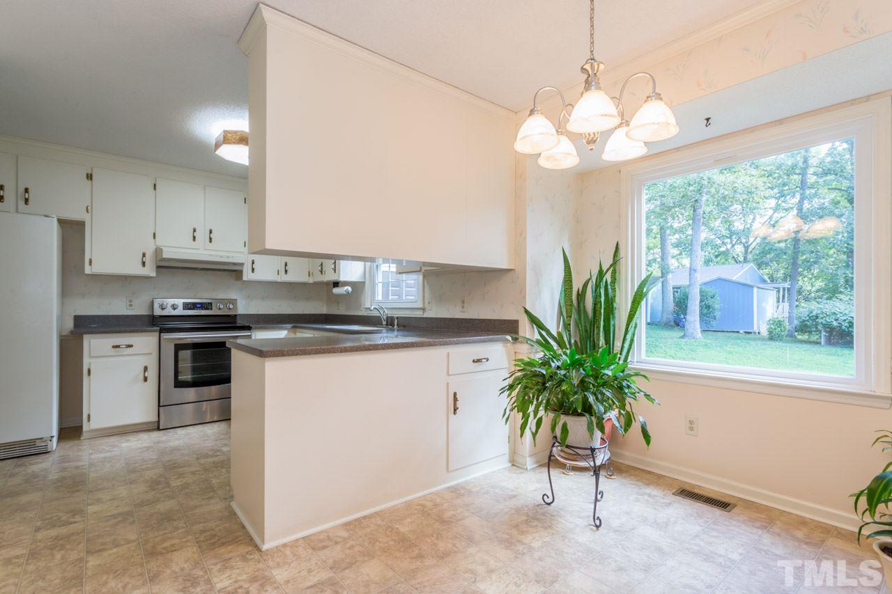 7324 Mill Ridge Road Raleigh, NC 27613 - Photo 14 of 24 a kitchen with stainless steel appliances granite countertop a window a sink and a white cabinets