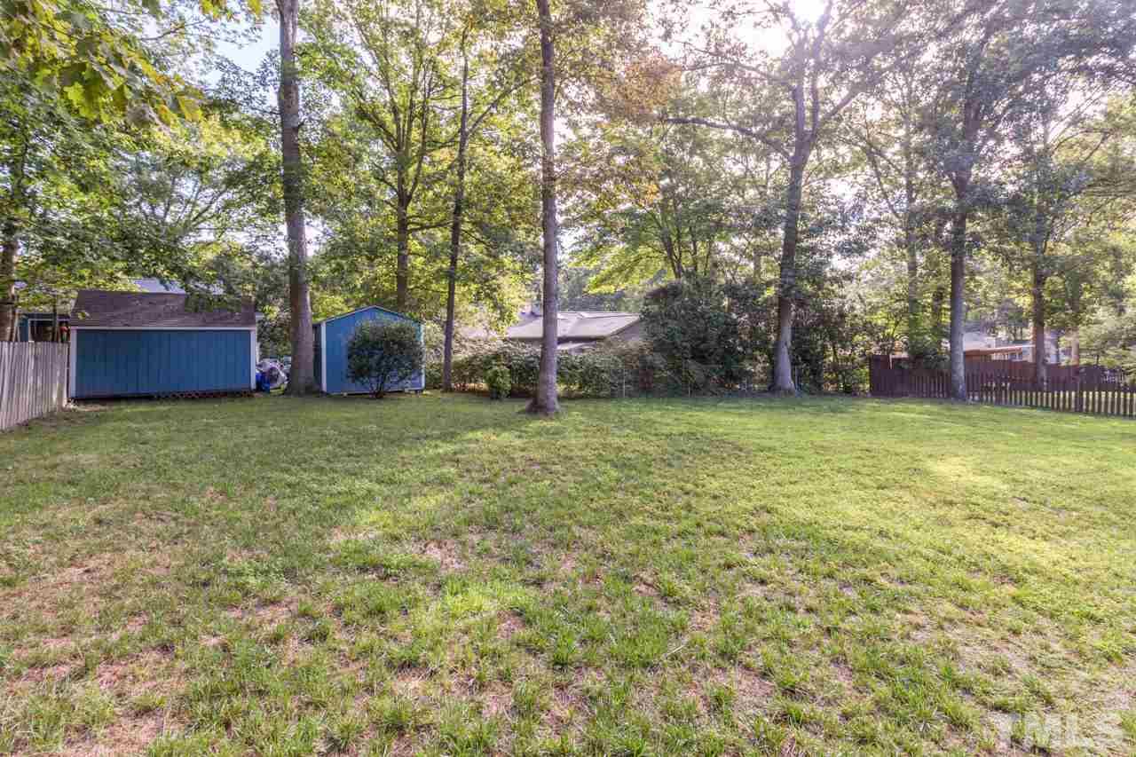 7324 Mill Ridge Road Raleigh, NC 27613 - Photo 3 of 24 a view of a backyard with large trees