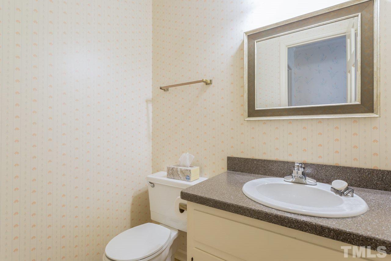 7324 Mill Ridge Road Raleigh, NC 27613 - Photo 24 of 24 a bathroom with a toilet sink and mirror