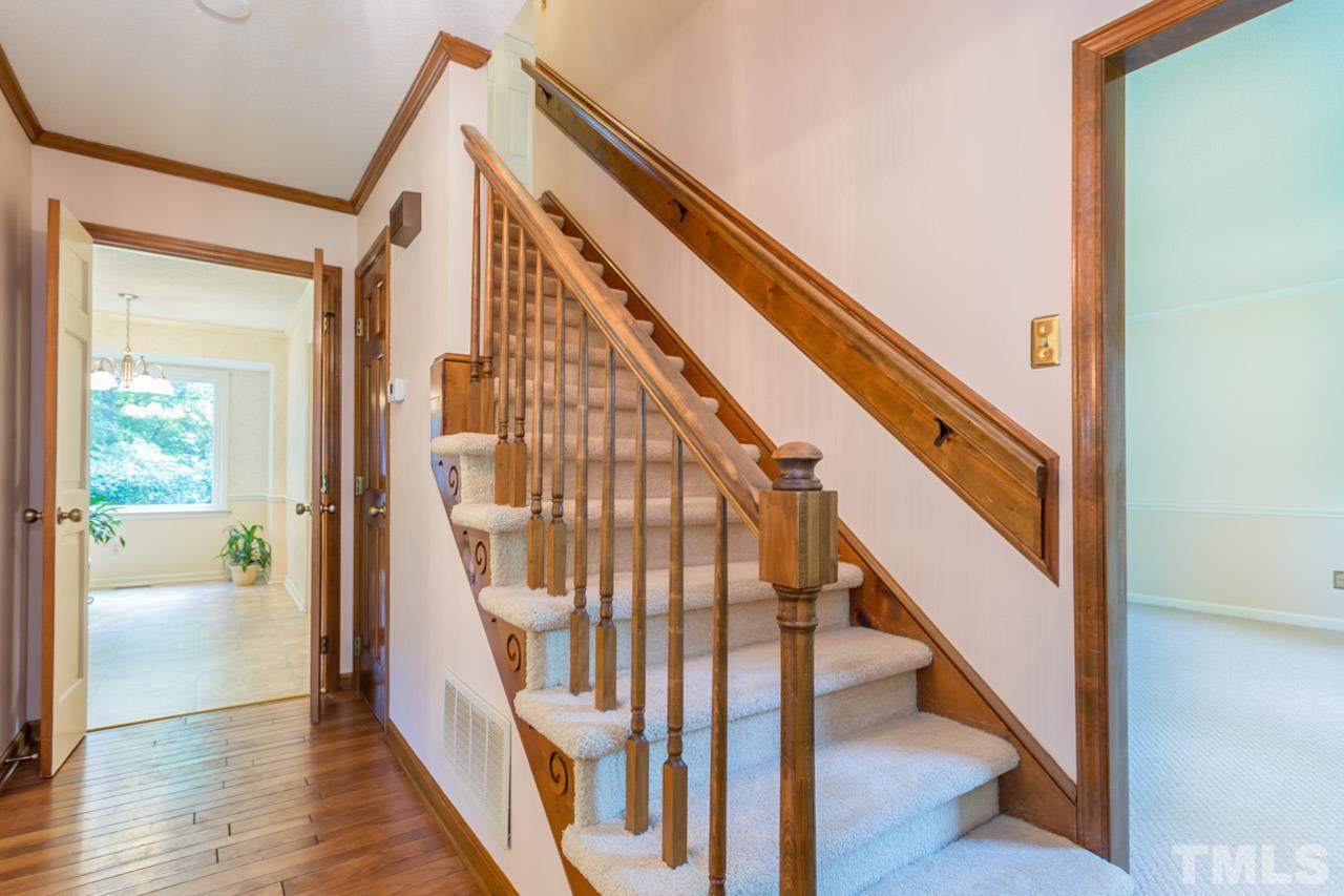 7324 Mill Ridge Road Raleigh, NC 27613 - Photo 7 of 24 a view of staircase with wooden floor and white walls