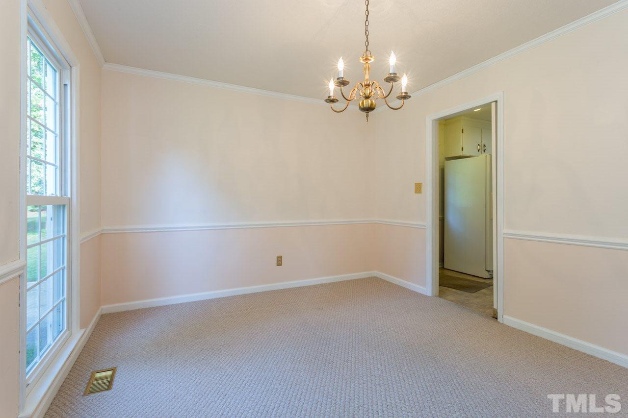 7324 Mill Ridge Road Raleigh, NC 27613 - Photo 10 of 24 wooden floor in an empty room with a window
