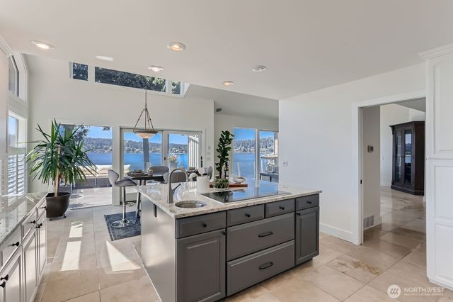 a kitchen with a refrigerator a sink and wooden cabinets