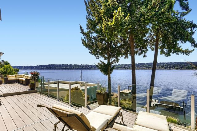 a view of a balcony with chairs and an umbrella