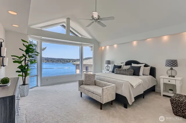 a spacious bedroom with a bed and a potted plant