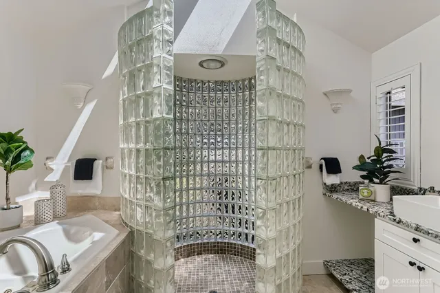 a bathroom with a sink a mirror and shower