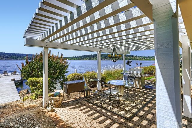 a view of a chairs and bench in patio