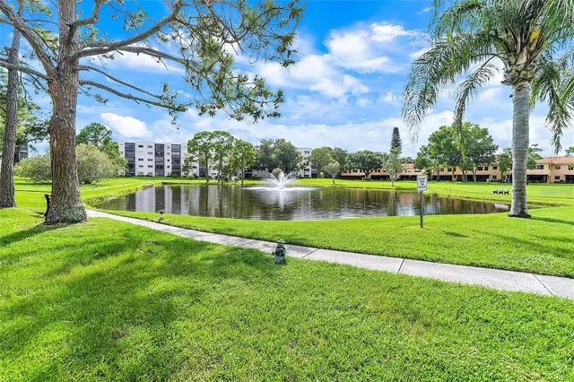 a living room with patio furniture and floor to ceiling window