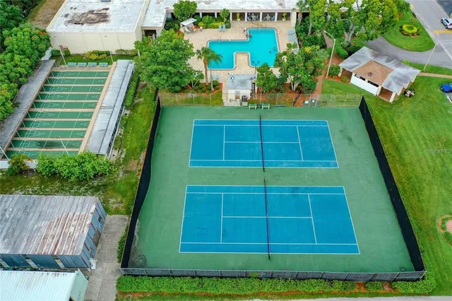 a view of a swimming pool with a patio and a fire pit