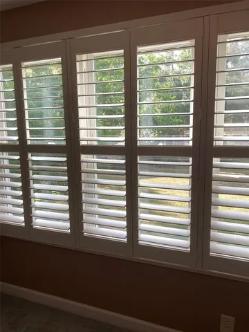 a kitchen with wooden cabinets and a window