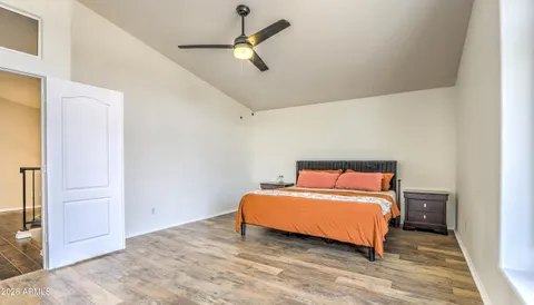 a room with a bed and a ceiling fan