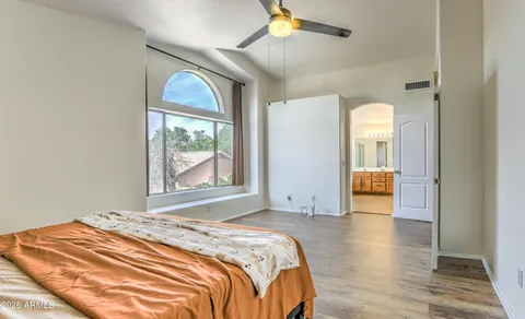 a bedroom with a bed and a window