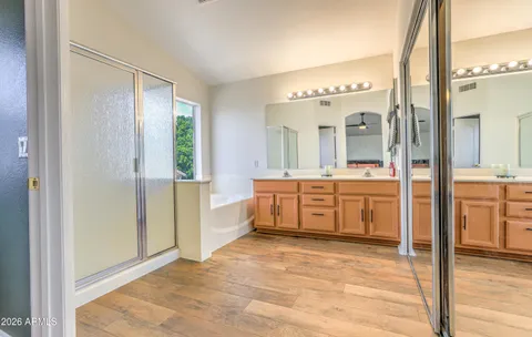 a spacious bathroom with a mirror sink and bathtub