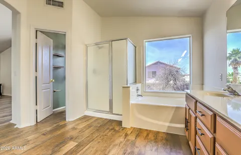 a view of room with window and wooden floor