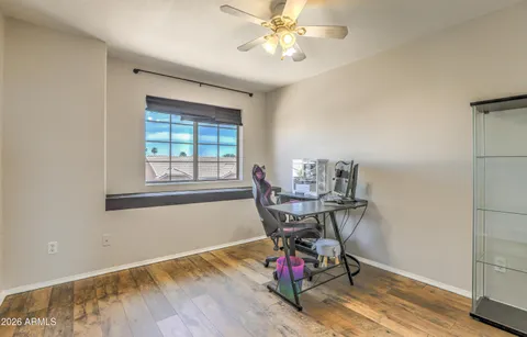 a view of a workspace with furniture and a window