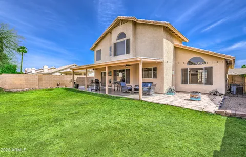 a view of a house with a yard porch and sitting area