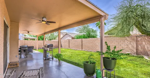 a view of a chair and tables in the patio