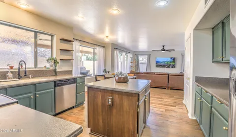 a kitchen with sink stove and cabinets
