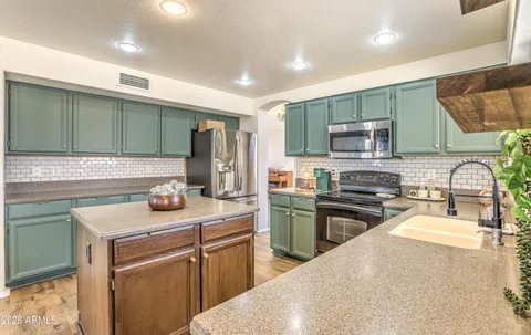 a kitchen with a sink stove and microwave