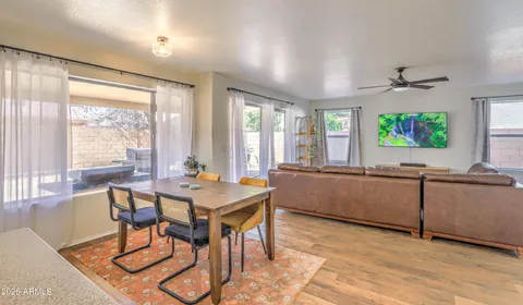 a view of a dining room with furniture a chandelier and wooden floor