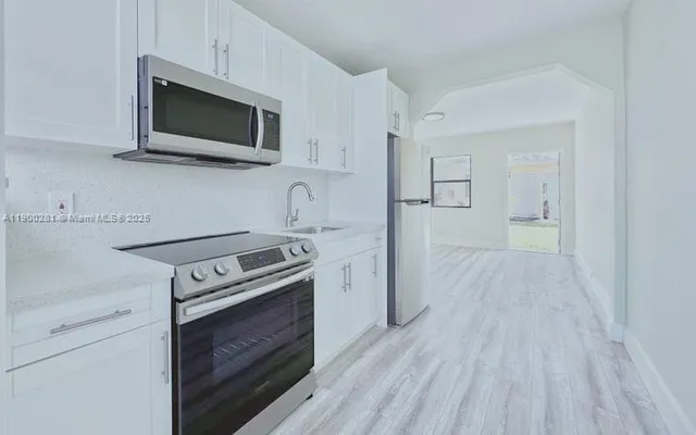 a kitchen with a stove and a microwave
