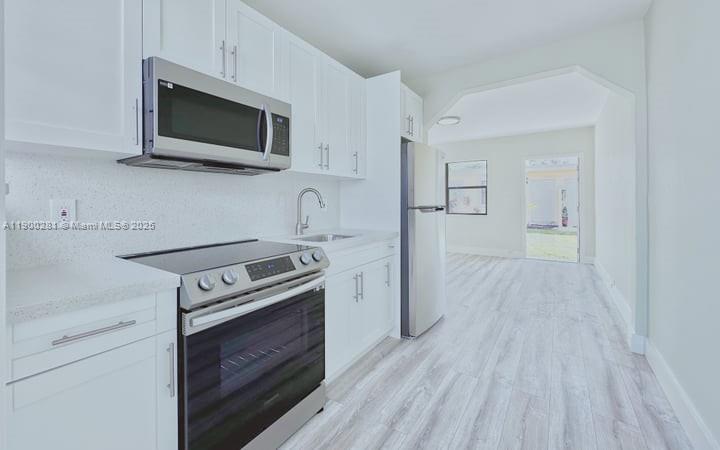 1010 Opa-locka Boulevard, Unit 2 Opa-Locka, FL 33054 - Photo 11 of 13 a kitchen with a stove and a microwave