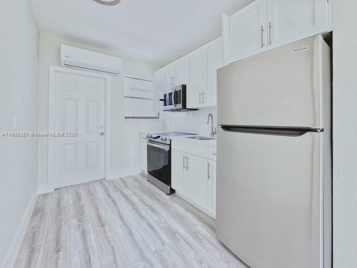 1010 Opa-locka Boulevard, Unit 2 Opa-Locka, FL 33054 - Photo 13 of 13 a kitchen with white cabinets and white appliances