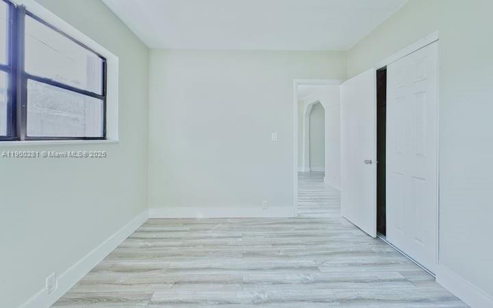 1010 Opa-locka Boulevard, Unit 2 Opa-Locka, FL 33054 - Photo 7 of 13 a view of an empty room with wooden floor and a window
