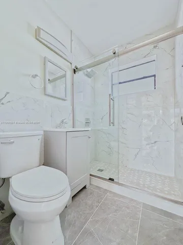 a bathroom with a toilet and a shower