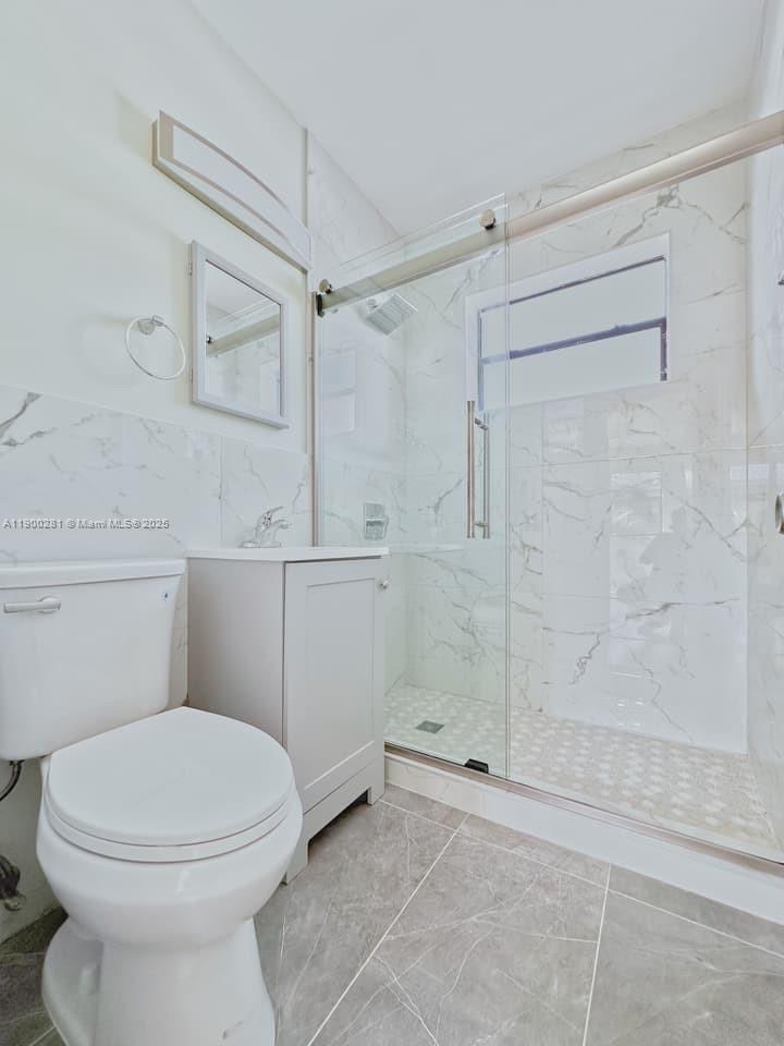 1010 Opa-locka Boulevard, Unit 2 Opa-Locka, FL 33054 - Photo 9 of 13 a bathroom with a toilet and a shower