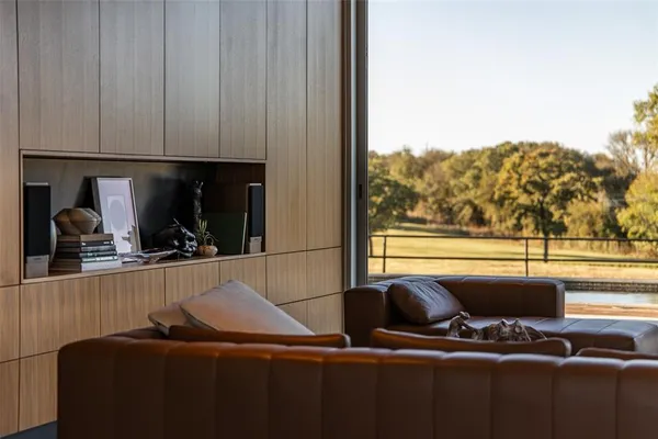 a living room with furniture a flat screen tv and a window