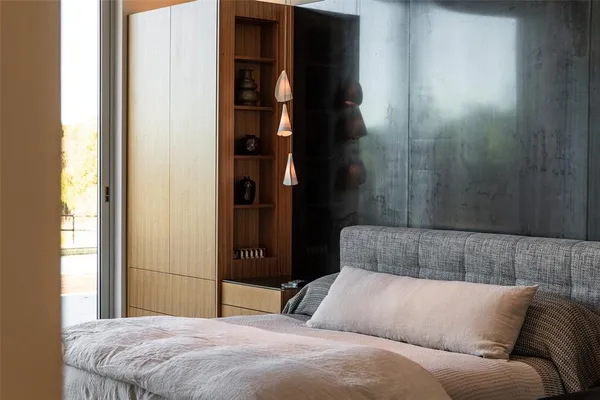 a bedroom with a bed and a window