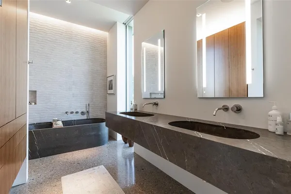 a bathroom with a bathtub sink and mirror