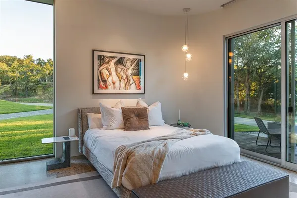 a bedroom with a bed and a large window