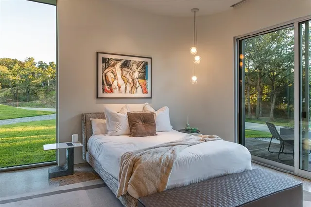 a bedroom with a bed and a large window