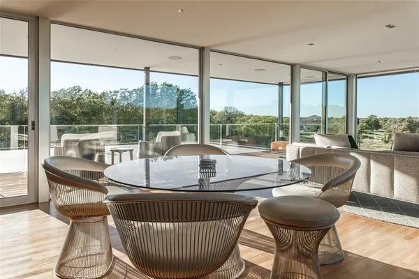 a living room with furniture and a floor to ceiling window