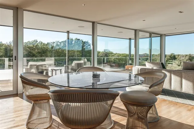 a living room with furniture and a floor to ceiling window
