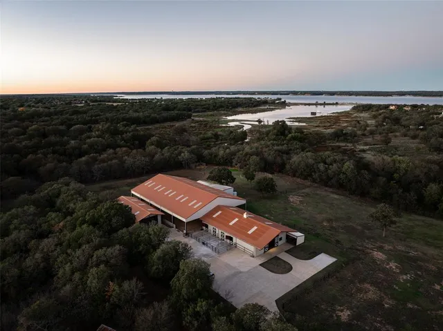 an aerial view of a house with a yard