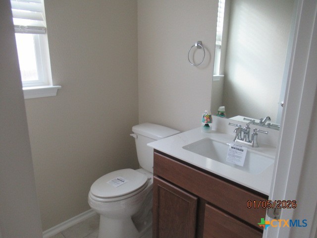 195 Azure Cove Kyle, TX 78640 - Photo 5 of 36 a bathroom with a toilet sink vanity and mirror