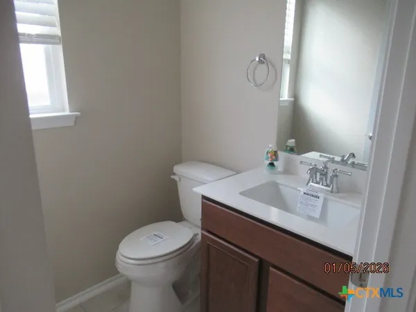a bathroom with a double vanity sink a mirror and a bathtub