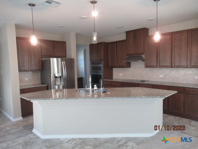 195 Azure Cove Kyle, TX 78640 - Photo 9 of 36 a kitchen with stainless steel appliances granite countertop a sink a refrigerator a stove and a center island