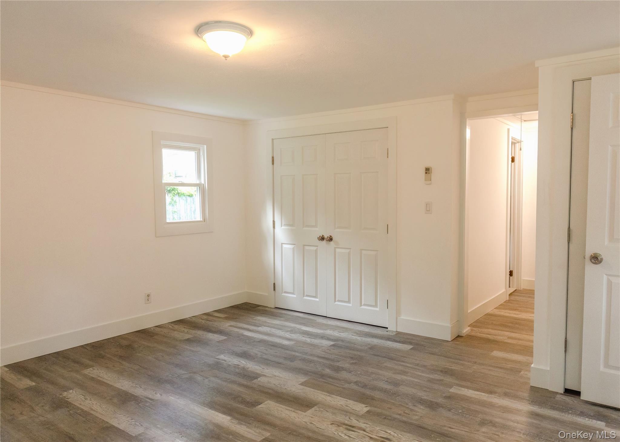 23 Lucille Road Carmel, NY 10512 - Photo 19 of 44 an empty room with wooden floor and windows